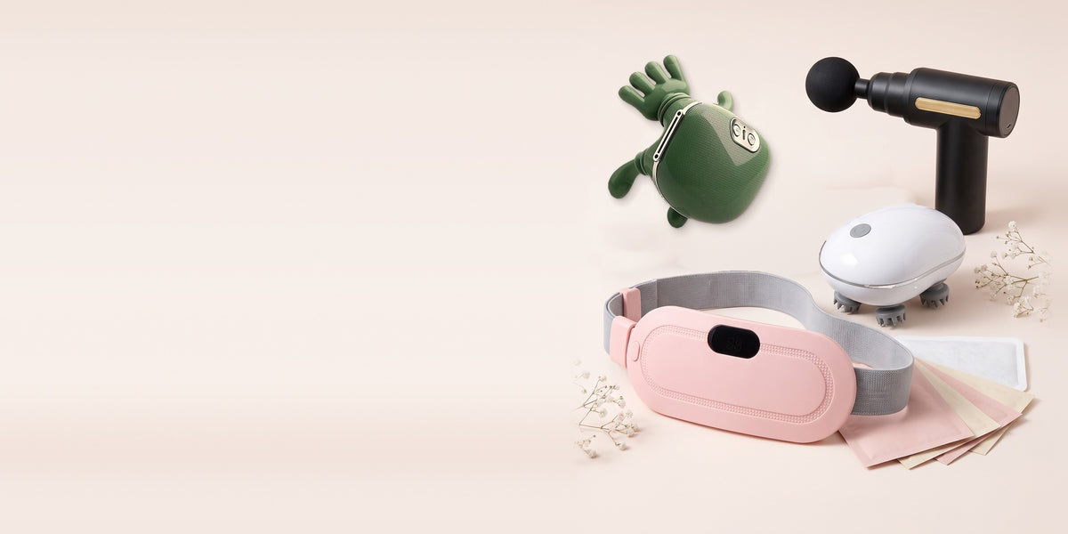 Warmly.pk products: pink LED period heating belt in front, with neck massager, mini massage gun, scalp massager and body heat patches